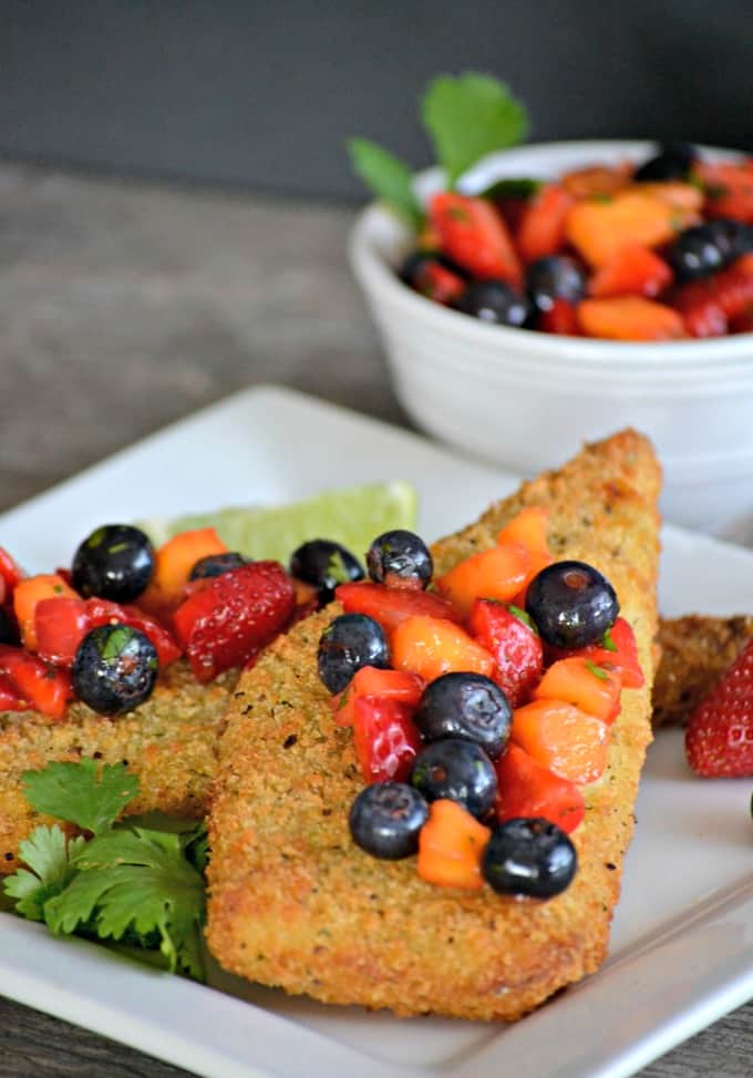 Parmesan crusted Cod accompanied by a fresh strawberry, blueberry and mango salsa - a delicious and easy dinner that's ready in under 30 minutes!