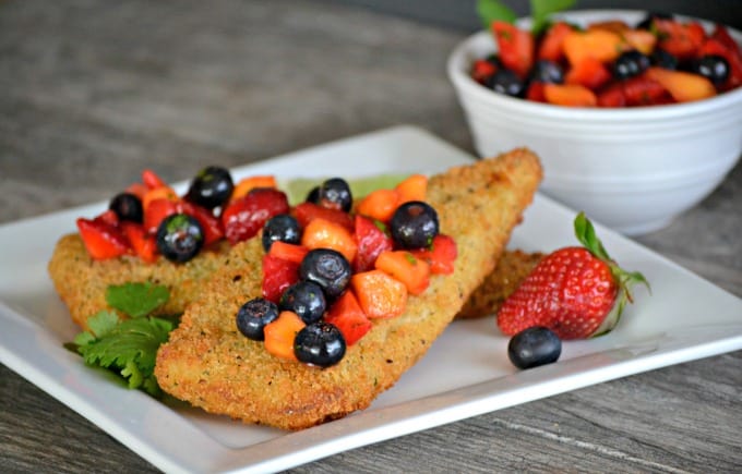 Parmesan crusted Cod accompanied by a fresh strawberry, blueberry and mango salsa - a delicious and easy dinner that's ready in under 30 minutes!