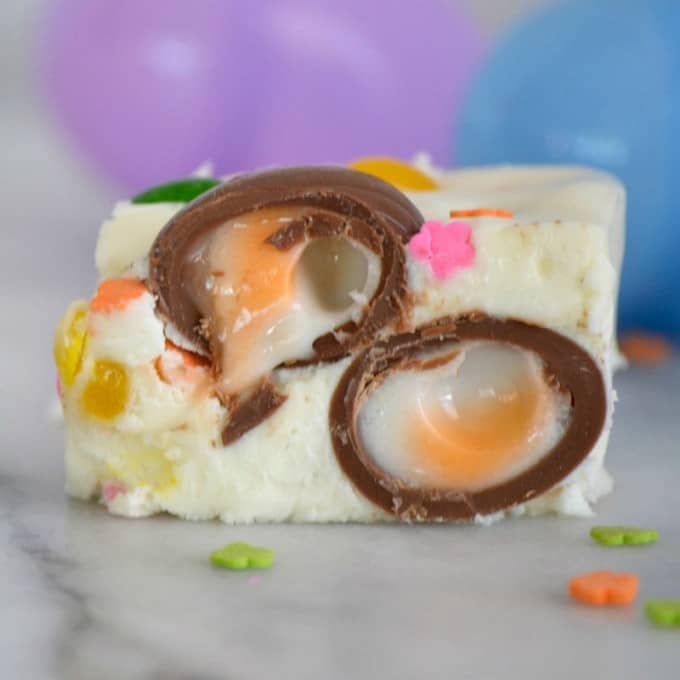 Easter Fudge is white chocolate with mini Cadbury Creme Eggs, and Starburst Jelly Beans - the perfect sweet treat to serve your little bunnies for Easter!