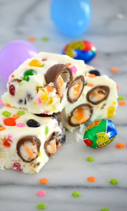 Easter Fudge is white chocolate with mini Cadbury Creme Eggs, and Starburst Jelly Beans - the perfect sweet treat to serve your little bunnies for Easter!