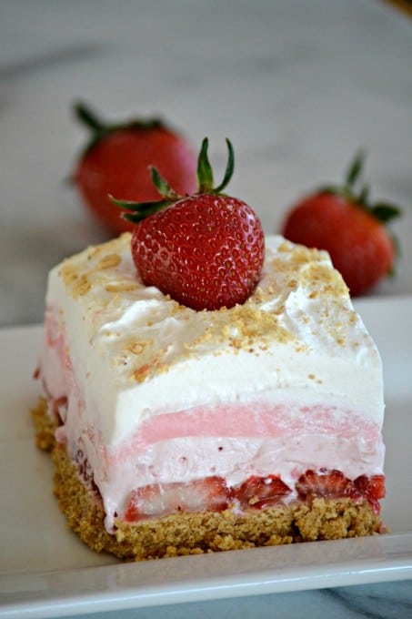 These Strawberry Cheesecake Dream Bars are layers of graham crackers, strawberries, and more. It's the perfect NO-BAKE dessert for strawberry season!