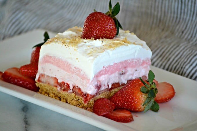These Strawberry Cheesecake Dream Bars are layers of graham crackers, strawberries, and more. It's the perfect NO-BAKE dessert for strawberry season!