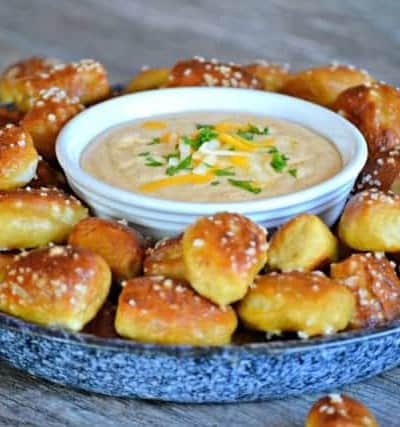 This Beer Cheese Dip and Homemade Pretzel Bites is a smooth, slightly spicy cheese dip with a touch of your favorite brew that goes perfectly with the easy homemade pretzel bites.
