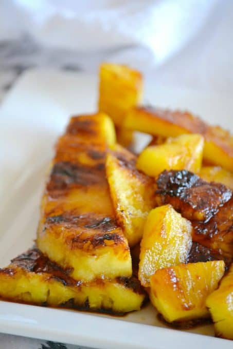 This Grilled Pineapple is soaked in rum, coated in brown sugar and grilled. It's perfect as a simple dessert or as a topping over ice cream.