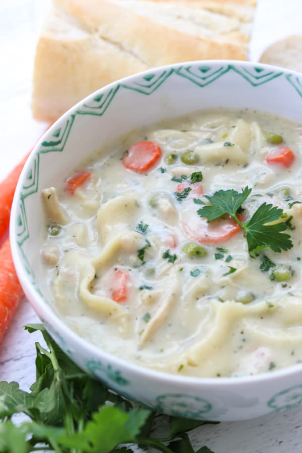 This creamy Homemade Chicken Noodle Soup recipe with chicken, noodles, peas and carrots is a flavorful dish that is super easy to make.