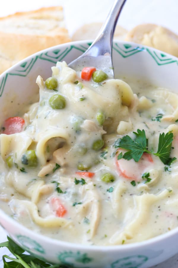 This creamy Homemade Chicken Noodle Soup recipe with chicken, noodles, peas and carrots is a flavorful dish that is super easy to make.