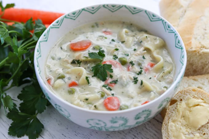 This creamy Homemade Chicken Noodle Soup recipe with chicken, noodles, peas and carrots is a flavorful dish that is super easy to make.