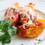 Pepperoni Pizza Stuffed Shells are pasta shells stuffed with ricotta and Parmesan cheese, diced pepperoni, and topped with pizza sauce. 