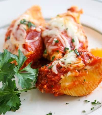 Pepperoni Pizza Stuffed Shells are pasta shells stuffed with ricotta and Parmesan cheese, diced pepperoni, and topped with pizza sauce. 