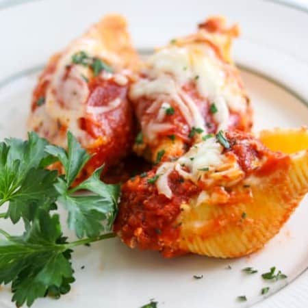 Pepperoni Pizza Stuffed Shells are pasta shells stuffed with ricotta and Parmesan cheese, diced pepperoni, and topped with pizza sauce.
