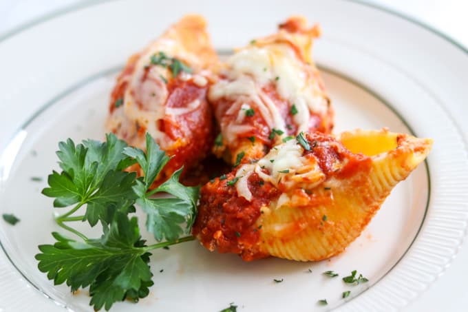 Pepperoni Pizza Stuffed Shells are pasta shells stuffed with ricotta and Parmesan cheese, diced pepperoni, and topped with pizza sauce. 