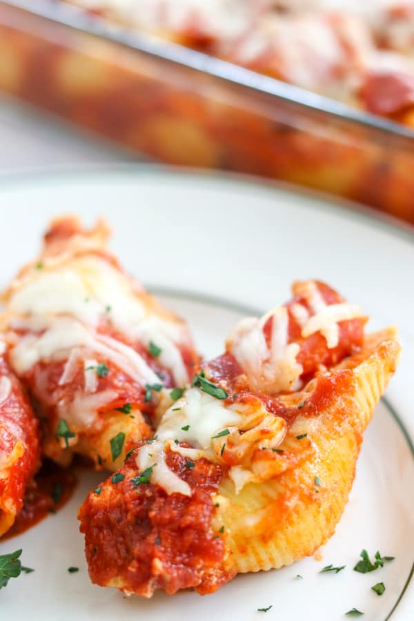 Pepperoni Pizza Stuffed Shells are pasta shells stuffed with ricotta and Parmesan cheese, diced pepperoni, and topped with pizza sauce. 