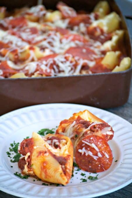 Pepperoni Pizza Stuffed Shells - pasta shells stuffed with ricotta and parmesan cheese, diced pepperoni and topped with pizza sauce. A great idea for Pizza night!