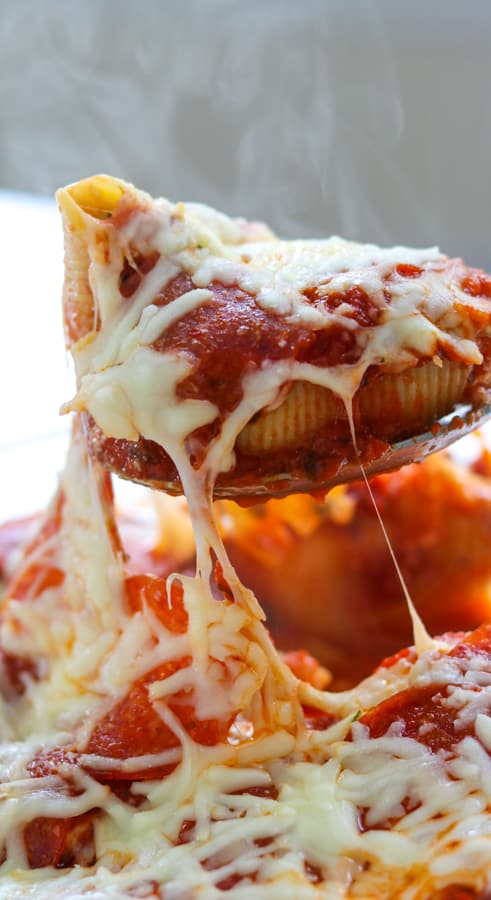Pepperoni Pizza Stuffed Shells are pasta shells stuffed with ricotta and Parmesan cheese, diced pepperoni, and topped with pizza sauce. 