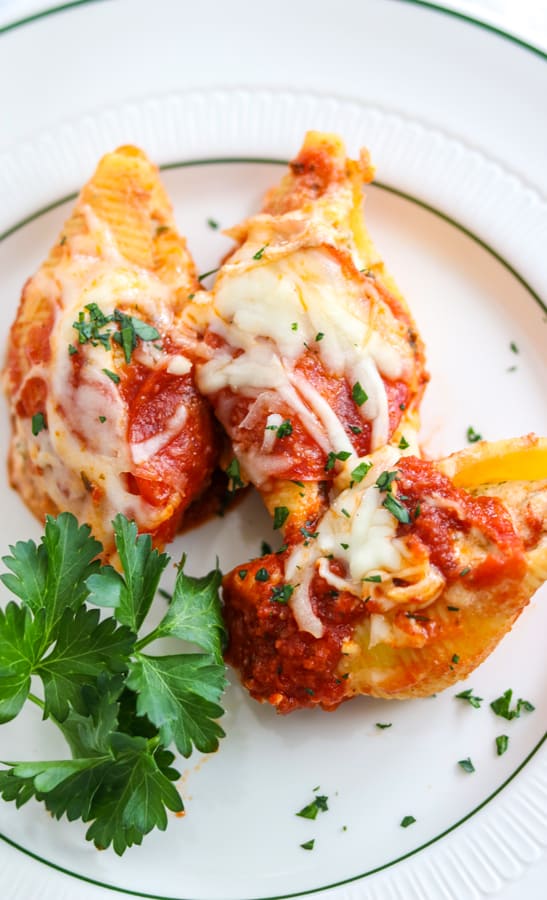 Pepperoni Pizza Stuffed Shells are pasta shells stuffed with ricotta and Parmesan cheese, diced pepperoni, and topped with pizza sauce. 