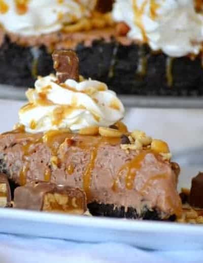 This No Bake Nutella Snickers Pie from Julianne Bayer's cookbook, No Bake Treats: Incredible Unbaked Cheesecakes, Icebox Cakes, Pies and More, is going to be a hit this summer with the delicious creamy Nutella filling, salted caramel and chopped Snickers on top.