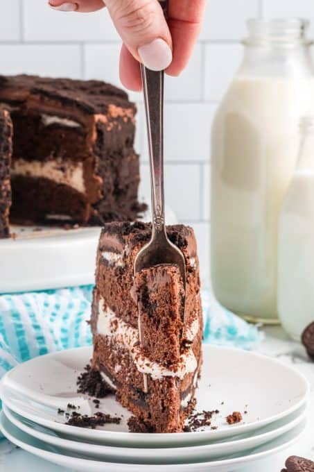 Taking a bite of an cake made with Oreos.