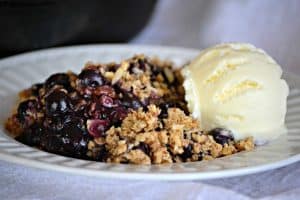 This Skillet Blueberry Crisp with fresh blueberries, an almond oatmeal topping and topped with a scoop of vanilla ice cream, make it the perfect dessert!