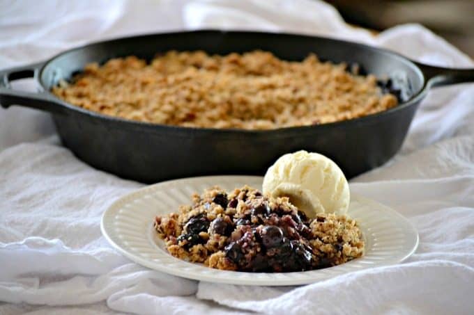 This Skillet Blueberry Crisp with fresh blueberries, an almond oatmeal topping and topped with a scoop of vanilla ice cream, make it the perfect dessert! 