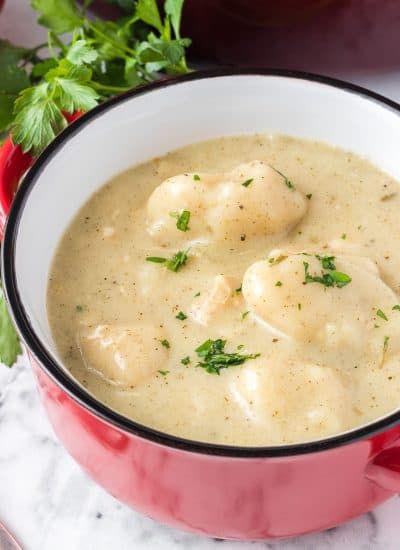 A bowl of dumplings made from scratch in a thick chicken soup.