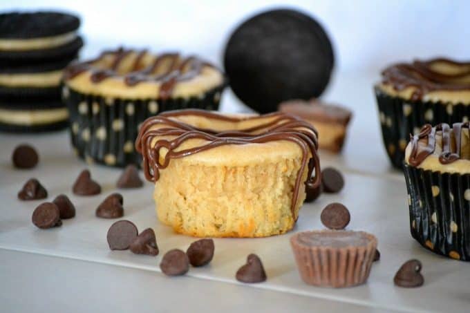 These Mini Peanut Butter Cup Cheesecakes are individually sized peanut butter cheesecakes with a surprise mini Reese's Peanut Butter Cup, drizzled with chocolate. Chocolate and peanut butter lovers will go nuts!