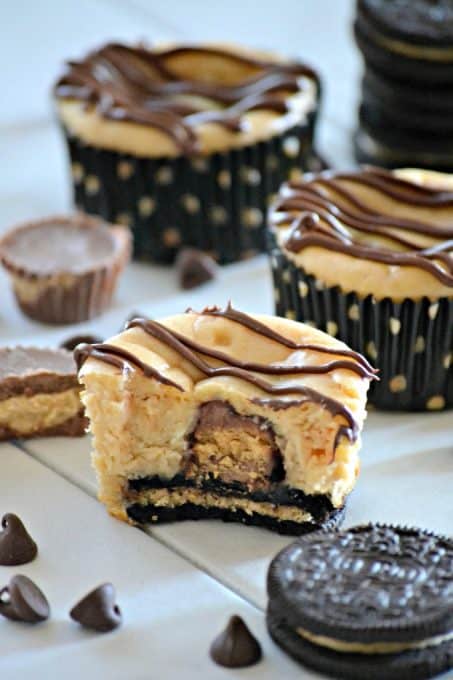 These Mini Peanut Butter Cup Cheesecakes are individually sized peanut butter cheesecakes with a surprise mini Reese's Peanut Butter Cup, drizzled with chocolate. Chocolate and peanut butter lovers will go nuts!