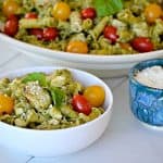 This Pesto Chicken Pasta Salad is pasta, diced chicken, tomatoes and diced mozzarella tossed in an easy pesto. It can also be a side without the chicken!