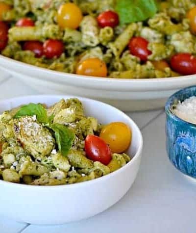 This Pesto Chicken Pasta Salad is pasta, diced chicken, tomatoes and diced mozzarella tossed in an easy pesto. It can also be a side without the chicken!