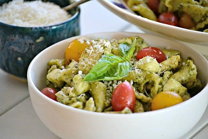 This Pesto Chicken Pasta Salad is pasta, diced chicken, tomatoes and diced mozzarella tossed in an easy pesto. It can also be a side without the chicken!