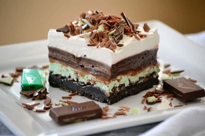 These Chocolate Mint Dream Bars are the perfect No-Bake dessert. The cookie crust, chopped Andes Mints, peppermint, pudding and whipped topping will have everyone swooning!