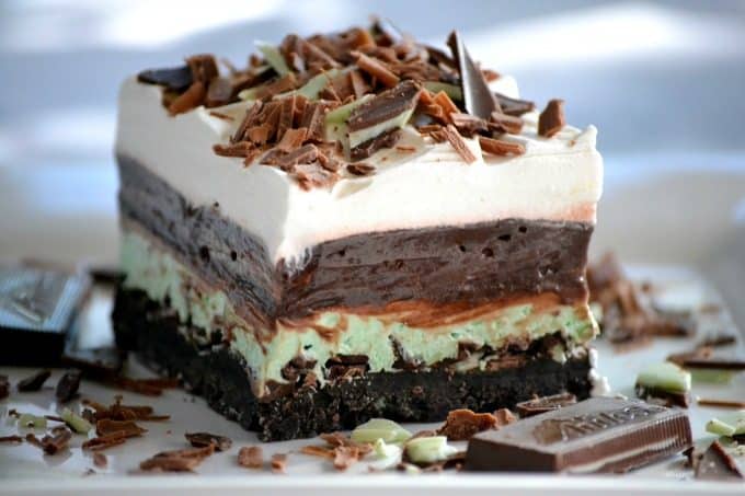 These Chocolate Mint Dream Bars are the perfect No-Bake dessert. The cookie crust, chopped Andes Mints, peppermint, pudding and whipped topping will have everyone swooning!