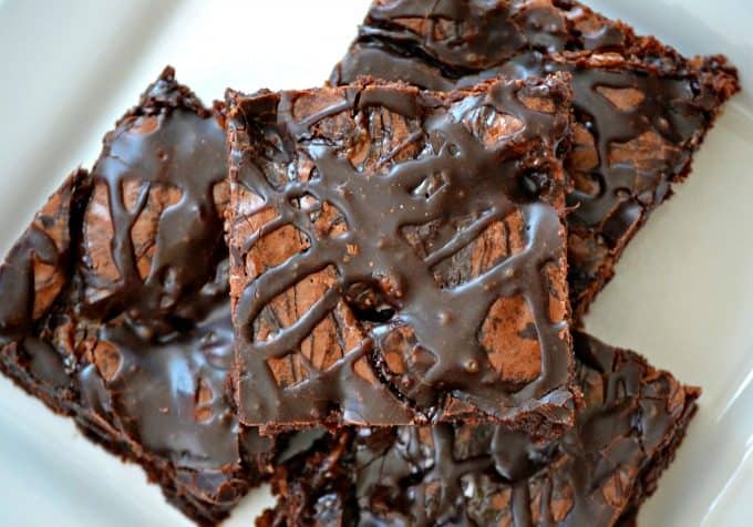 These Chocolate Overload Loaded Brownies are super easy - made with a box mix, chopped candy bars, chocolate sauce and drizzled with chocolate frosting. If you've got a chocolate or sweet tooth craving, these are sure to satisfy it!