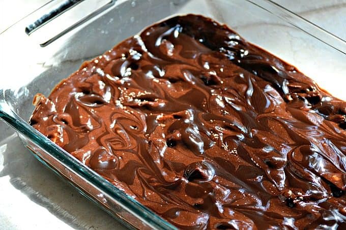 These Chocolate Overload Loaded Brownies are super easy - made with a box mix, chopped candy bars, chocolate sauce and drizzled with chocolate frosting. If you've got a chocolate or sweet tooth craving, these are sure to satisfy it!