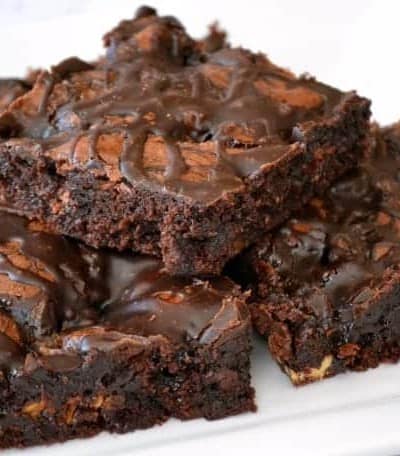 These Chocolate Overload Loaded Brownies are super easy - made with a box mix, chopped candy bars, chocolate sauce and drizzled with chocolate frosting. If you've got a chocolate or sweet tooth craving, these are sure to satisfy it!