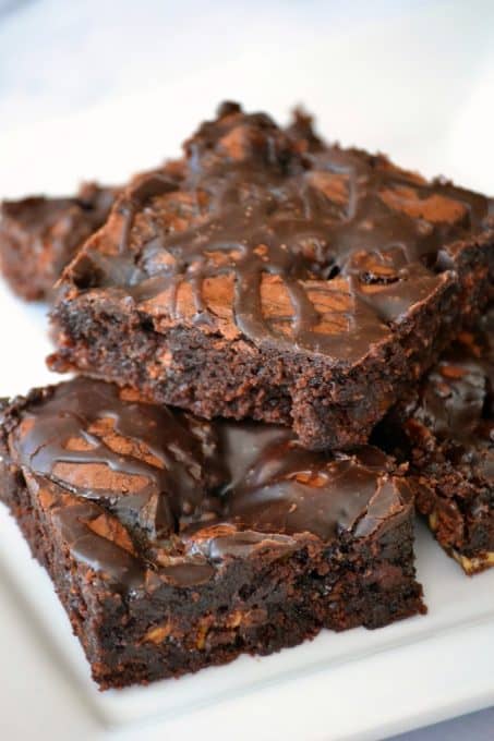 These Chocolate Overload Loaded Brownies are super easy - made with a box mix, chopped candy bars, chocolate sauce and drizzled with chocolate frosting. If you've got a chocolate or sweet tooth craving, these are sure to satisfy it!