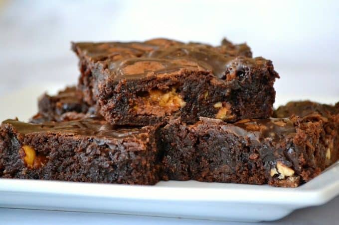 These Chocolate Overload Loaded Brownies are super easy - made with a box mix, chopped candy bars, chocolate sauce and drizzled with chocolate frosting. If you've got a chocolate or sweet tooth craving, these are sure to satisfy it!