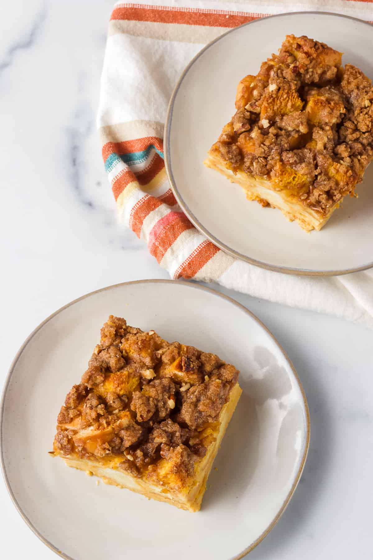 Pieces of Pumpkin baked French Toast on plates.