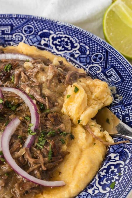 A bite of polenta and salsa verde short ribs.