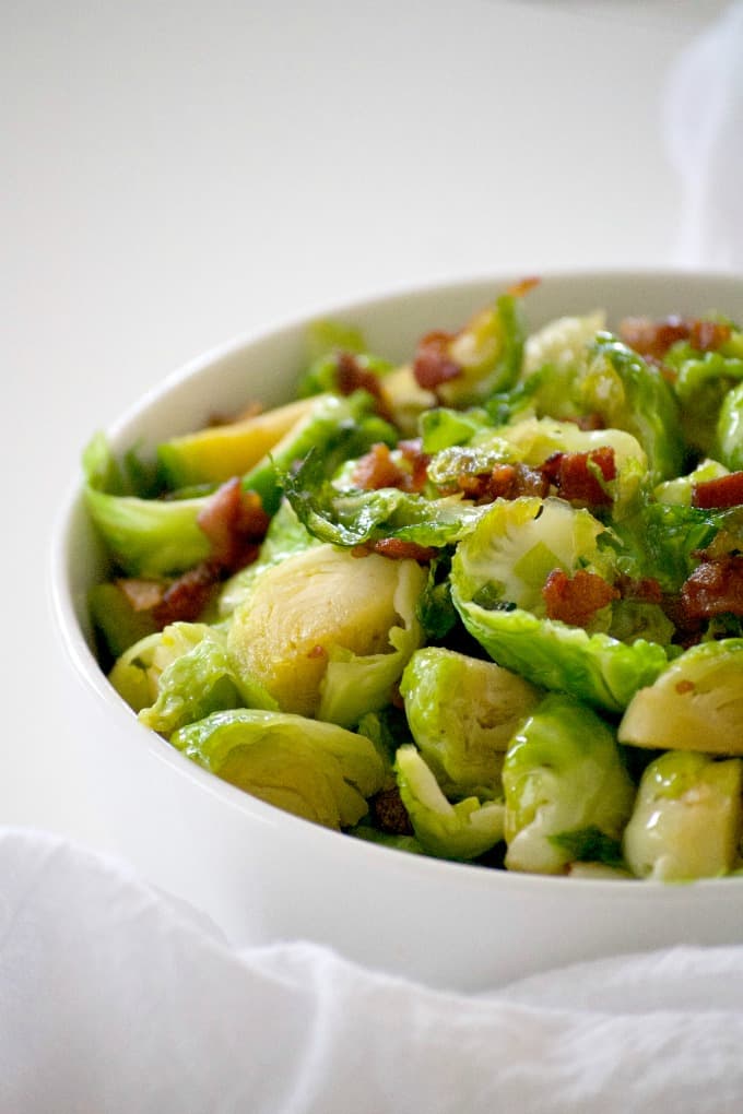 These Maple Bacon Brussels Sprouts are Brussels sprouts cooked in a skillet with bacon, some brown sugar and maple syrup. This is a great side dish to serve with any dinner and will convert your Brussels sprouts hater.