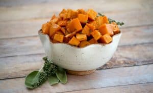 These Maple Roasted Sweet Potatoes are diced sweet potatoes tossed with olive oil, fresh sage and thyme, drizzled with pure maple syrup and roasted to perfection. They're the perfect side dish for your holiday table!