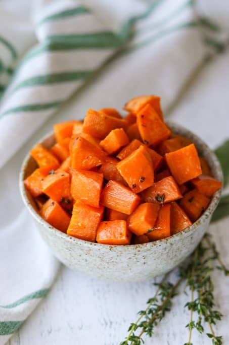 Roasted sweet potatoes with maple syrup and fresh herbs.