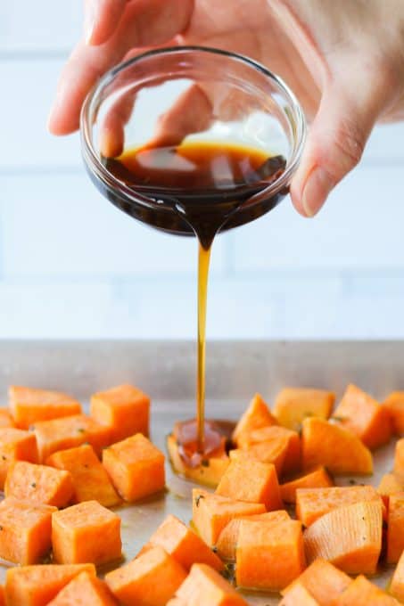 Drizzling maple syrup on sweet potatoes