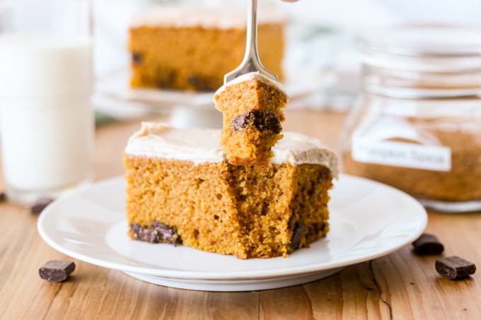 A bite take out of a pumpkin cake with chocolate chunks.