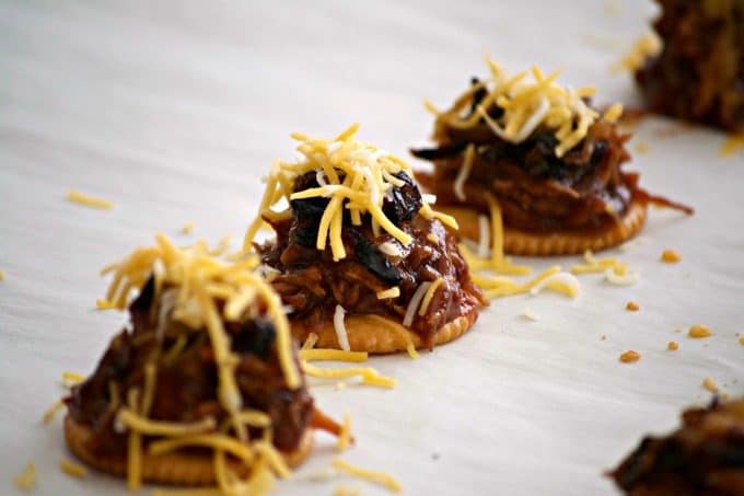 These Sweet and Spicy Coca-Cola Shredded Pork Bites are RITZ crackers topped with a bit of pork, caramelized onions, melted cheese and a dash of cilantro. Your Game Day taste buds will never be the same!