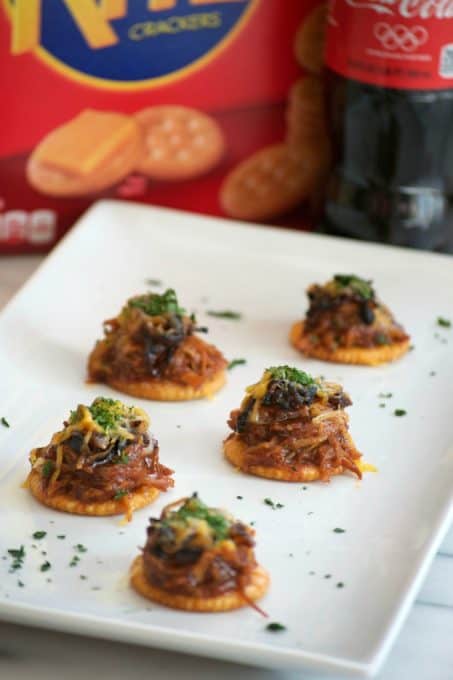 These Sweet and Spicy Coca-Cola Shredded Pork Bites are RITZ crackers topped with a bit of pork, caramelized onions, melted cheese and a dash of cilantro. Your Game Day taste buds will never be the same!