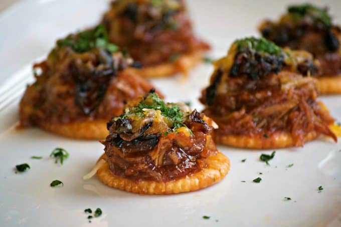 These Sweet and Spicy Coca-Cola Shredded Pork Bites are RITZ crackers topped with a bit of pork, caramelized onions, melted cheese and a dash of cilantro. Your Game Day taste buds will never be the same!