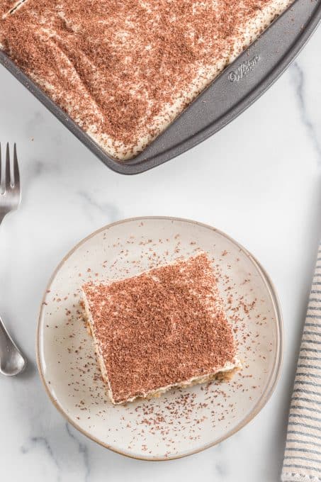 Top view of a white cake with coffee syrup.