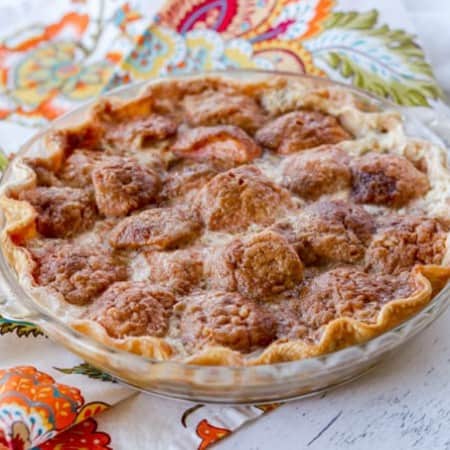 An apple pie with cinnamon sugar and heavy cream.