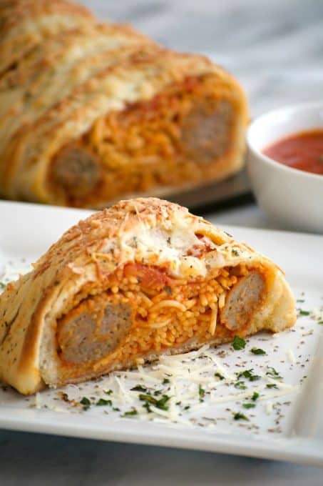 This Spaghetti and Meatball Braid is a new twist on good ol' comfort food - spaghetti and meatballs in pizza dough! It's a fun new way to feed the family.