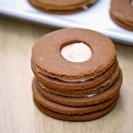 These Cream-Filled Molasses Cookies are a tasty gingerbread sandwich cookie with a cinnamon cream filling in the middle. They're great with a glass of milk!